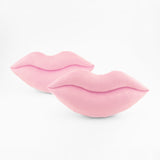 An offset pair of light baby pink lips shaped decorative pillows.
