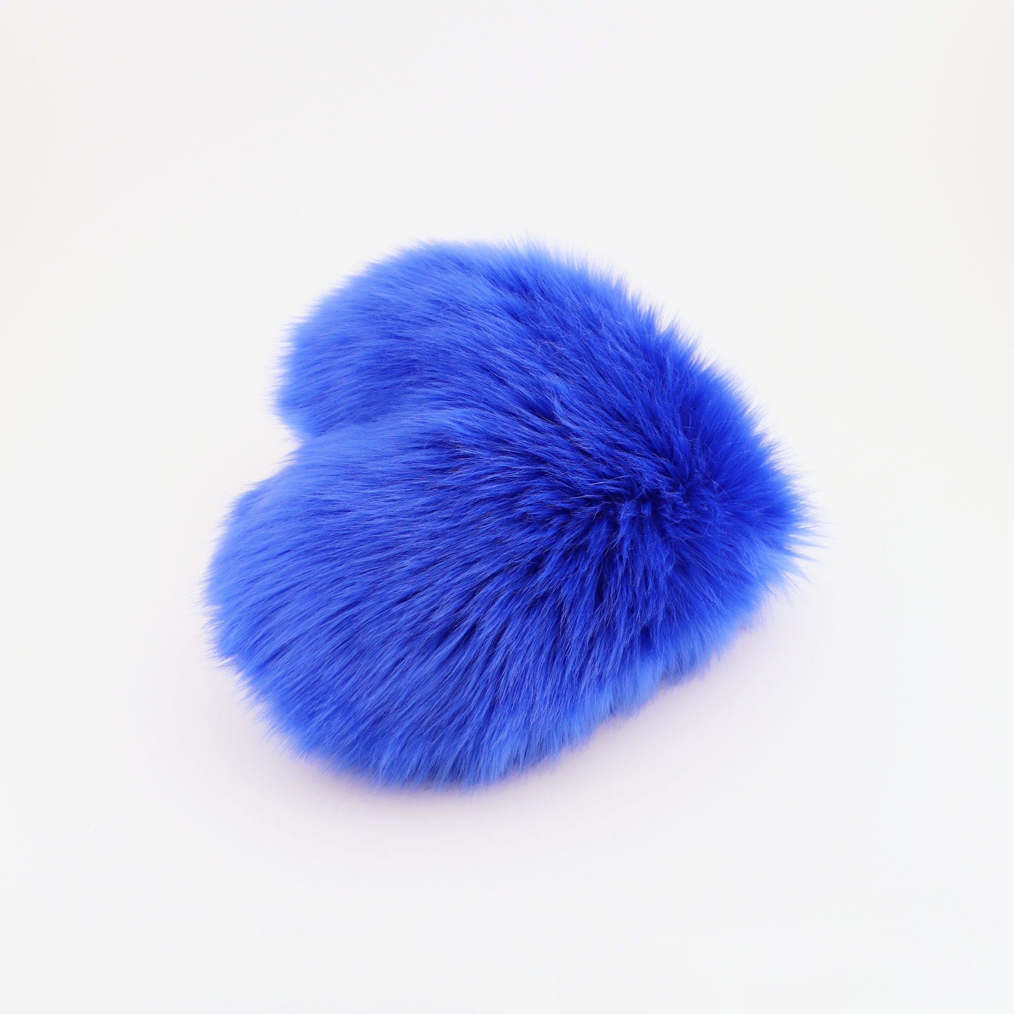 Side view of a Cobalt Blue faux fur heart shaped decorative pillow.