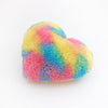 Angled view of a Fluffy Rainbow colored heart shaped decorative throw pillow.