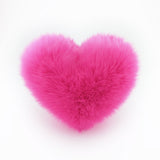 A Hot Pink heart shaped decorative throw pillow.