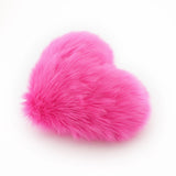 Side view of a Hot Pink heart shaped decorative throw pillow.
