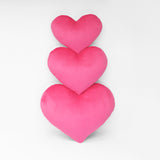 Three sizes of Hot Pink heart shaped decorative pillows.