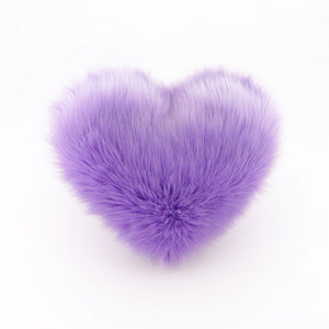 A Lavender faux fur heart shaped decorative pillow.