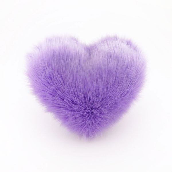 A Lavender faux fur heart shaped decorative pillow.