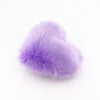 Side view of a Lavender faux fur heart shaped decorative pillow.