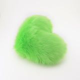 Side view of a Lime Green faux fur heart shaped decorative throw pillow.