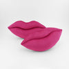 A pair of Magenta colored lips shaped decorative throw pillows.