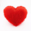 A Scarlet Red faux fur heart shaped decorative pillow.