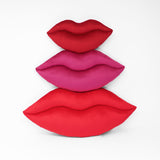 Lips shaped decorative toss pillows shown in three sizes.