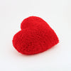 Side view of a Scarlet Red Curly Shag plush heart shaped decorative pillow.