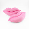 A pair of Bubble Gum Pink lips shaped decorative pillows.