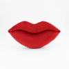 Single crimson red lips shaped decorative pillow.