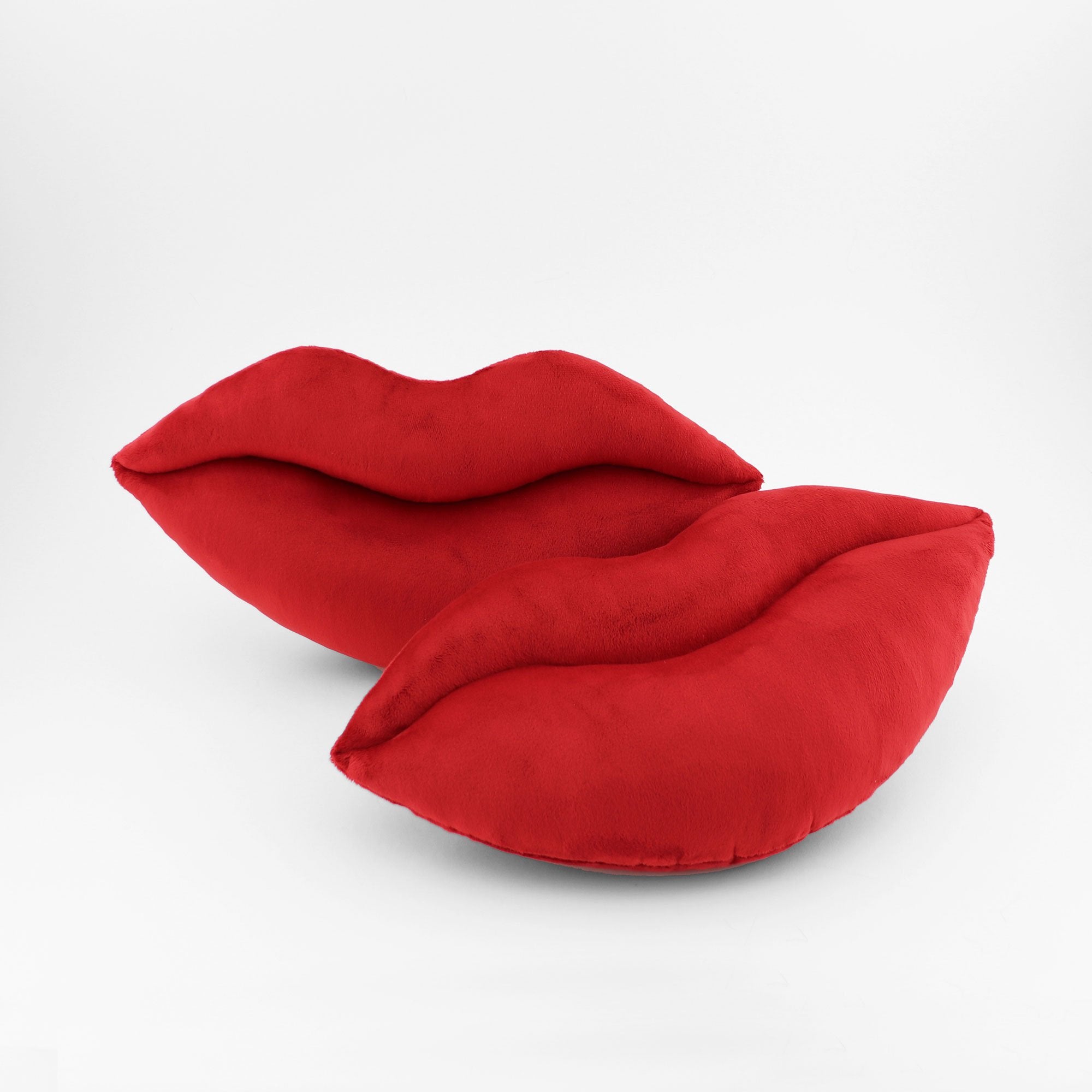 A pair of crimson red lips shaped decorative pillows.