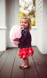 Little girl with Light Pink fluffy heart pillow.