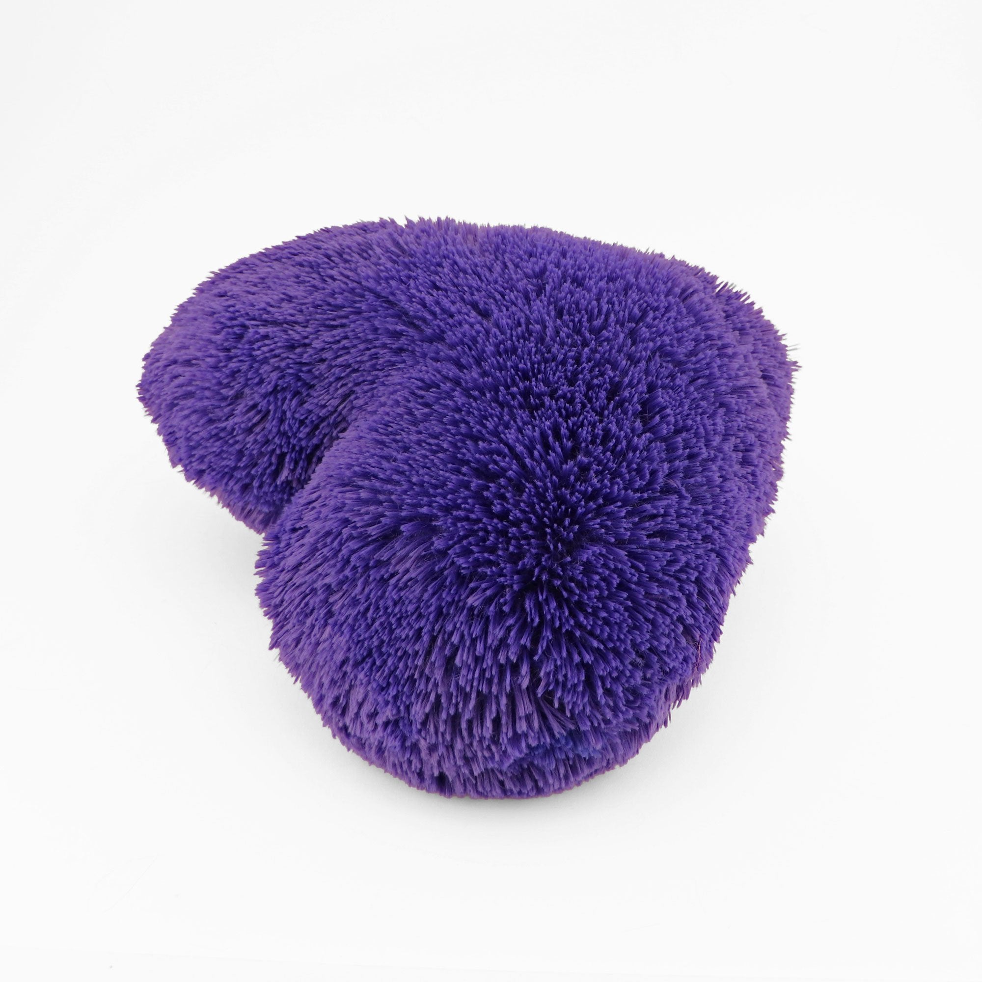 Side view of the Purple heart shaped decorative pillow in fluffy shag material.