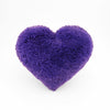 A Purple fluffy shag heart shaped decorative pillow.